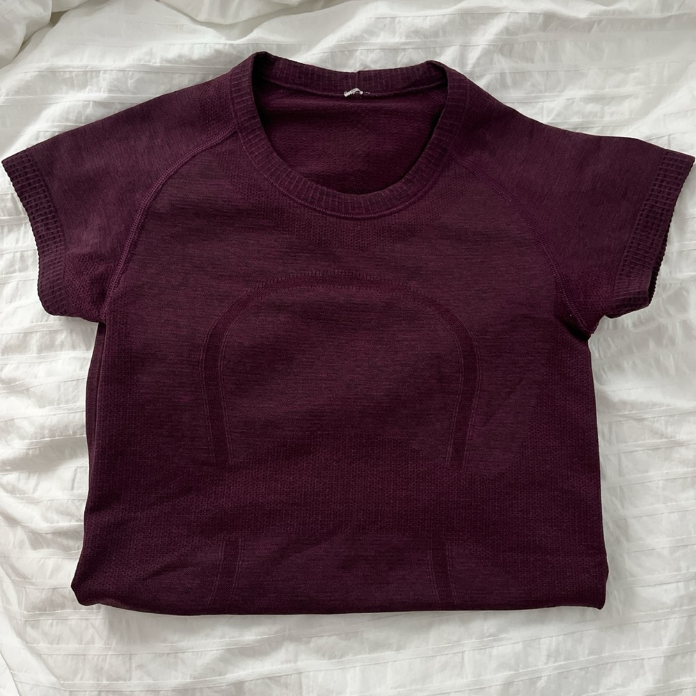 Plum /Merlot color swiftly tech lululemon short sleeve shirt size 2, hip length!